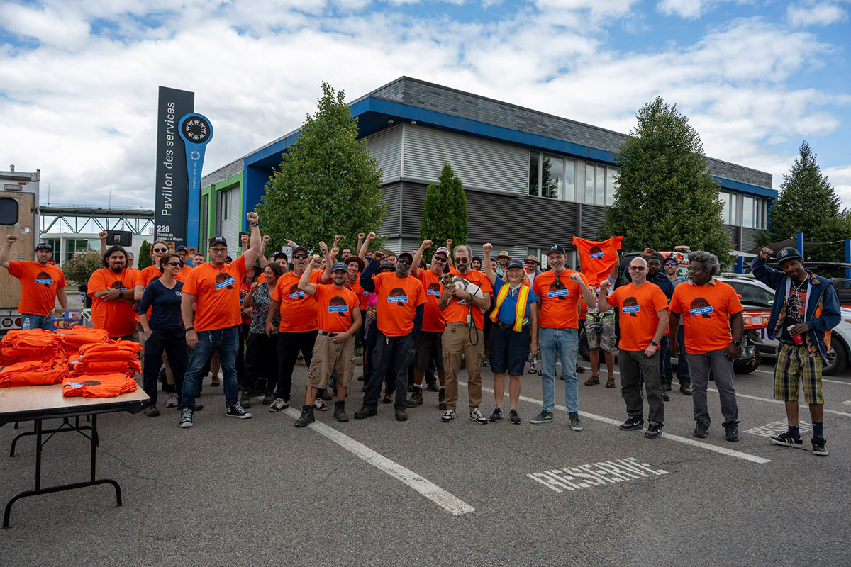 Workers in orange union t-shirts