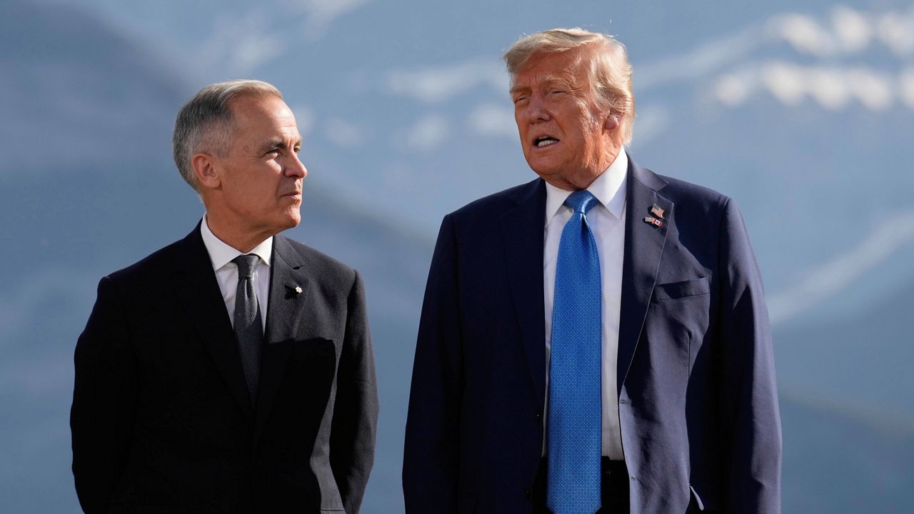 Canada's Prime Minister Mark Carney and U.S. President Donald Trumps pictured before a group photo at the G7 Summit, Monday, June 16, 2025, in Kananaskis, Canada. (AP Photo/Mark Schiefelbein)