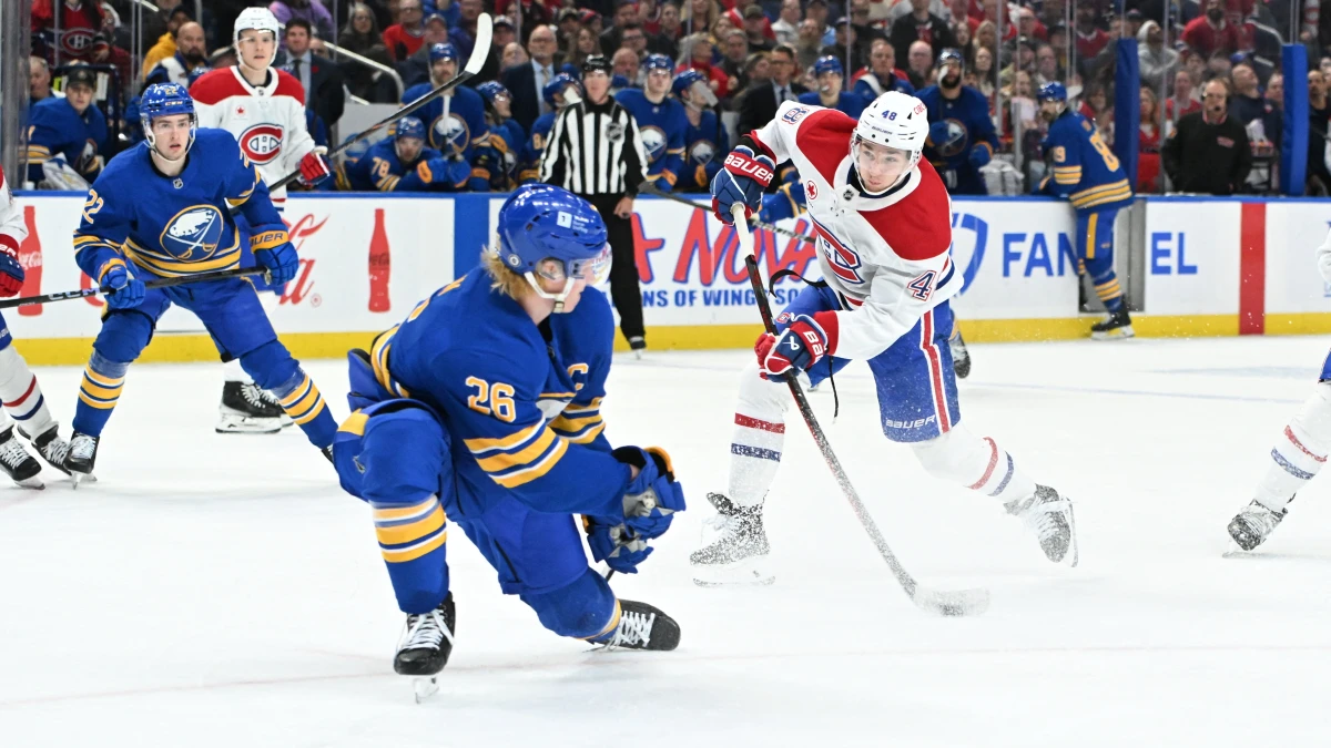 Montreal Canadiens defenseman Lane Hutson (48) shoots the puck with Buffalo Sabres defenseman Rasmus Dahlin (26) defending in the third period at KeyBank Center.