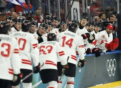 Feb 12, 2026; Milan, Italy; Bo Horvat of Canada celebrates scoring their third goal with teammates against Czechia in a men's ice hockey group A match during the Milano Cortina 2026 Olympic Winter Games at Milano Santagiulia Ice Hockey Arena. Mandatory Credit: Geoff Burke-Imagn Images