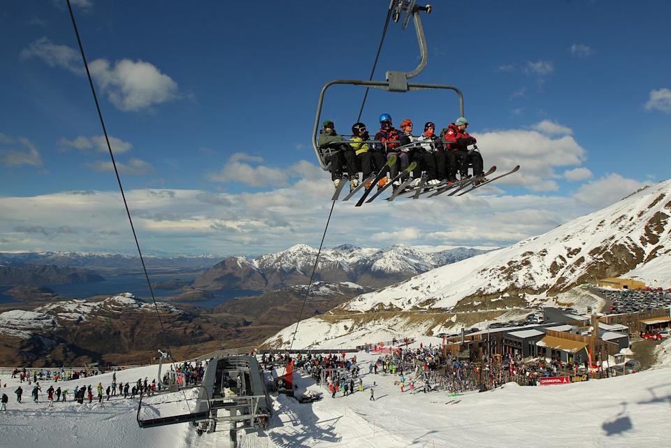 Skiers ride a chairlift at Treble Cone ski resort.Credit: Cameron Spencer/Getty Images
