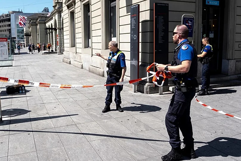 Police officers remove tape following a stabbing attack at the train station in Winterthur, 28 May, 2026