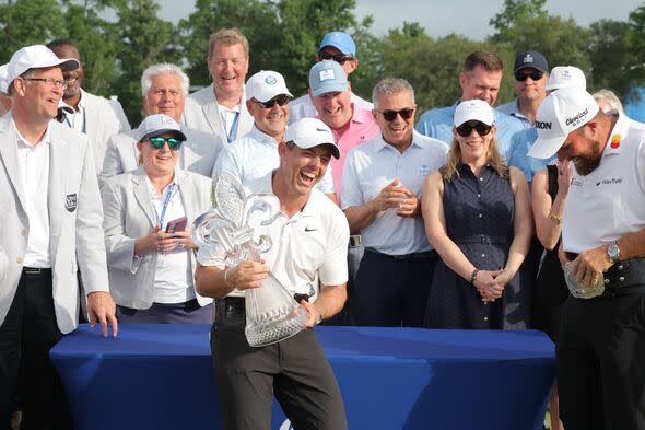 Rory McIlroy of Northern Ireland and Shane Lowry of Ireland pose with the Zurich Classic trophy