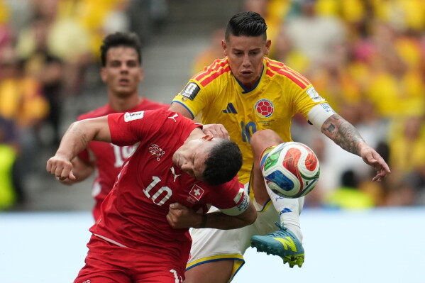 Switzerland's Granit Xhaka (10), left, and Colombia's James Rodriguez (10) fight for the ball during the World Cup round of 16 soccer match between Switzerland and Colombia in Vancouver, British Columbia, Tuesday, July 7, 2026. (AP Photo/Abbie Parr)