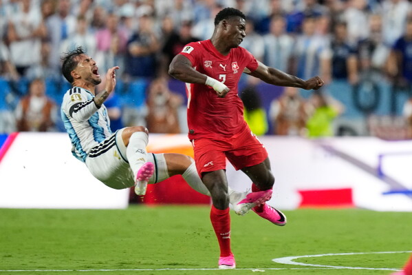 Argentina's Leandro Paredes (5) reacts as he is fouled by Switzerland's Breel Embolo (7) during the World Cup quarterfinal soccer match between Argentina and Switzerland in Kansas City, Mo., Saturday, July 11, 2026. (AP Photo/Ashley Landis)