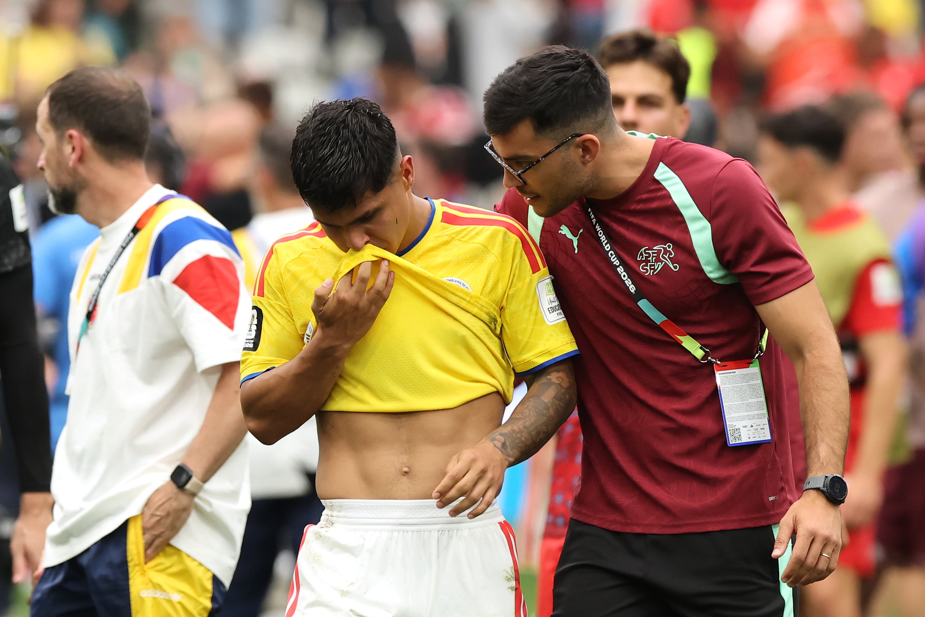Juan Quintero #20 of Colombia is consoled by a team staff of Switzerland