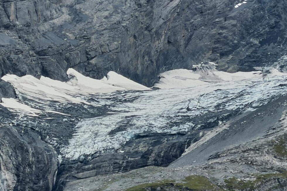 A looming rock collapse threatens a Swiss village as thawing permafrost destabilizes the Alps