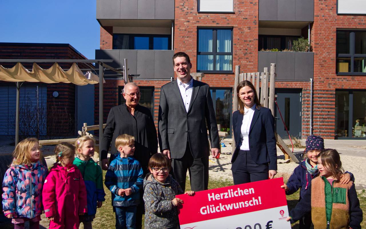 Drei Erwachsene und sieben Kinder zeigen die Spendensumme.