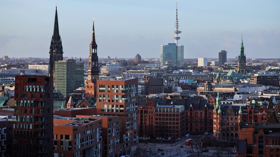 Der Hamburger Fernsehturm, das Rathaus und die Hauptkirchen St. Katharinen und Sankt Nikolai ragen aus den umliegenden Gebäuden der Hafencity, der Speicherstadt und der Innenstadt heraus. © picture alliance/dpa Foto: Christian Charisius