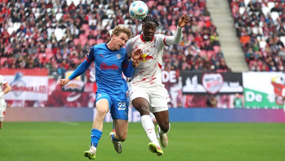 Kiels Lasse Rosenboom (l.) und Leipzigs El Chadaille Bitshiabu kämpfen um den Ball. © IMAGO / Beautiful Sports 