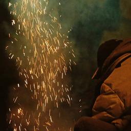Symbolbild:Eine Person steht neben einer gezündeten Silvesterrakete.(Quelle:imago images/Eibner)