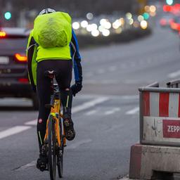 Ein Fahrradfahrer in neonfarbener Kleidung fährt auf einer Busspur auf der Klingelhöferstraße in Berlin. (Quelle: dpa/Monika Skolimowska)