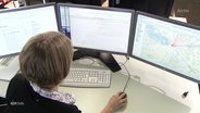 Eine Frau sitzt vor drei Monitoren. © Screenshot 