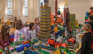 Kinder bauen eine Legostadt aus über hunderttausend bunten Steinen 