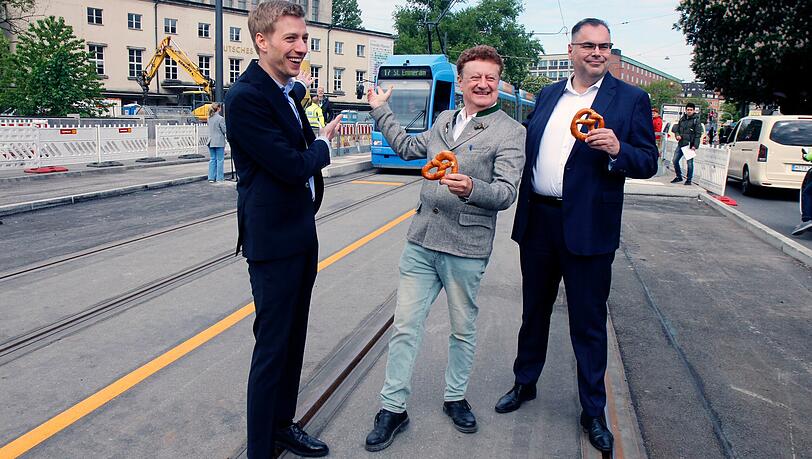 v.l.: Zweiter Oberbürgermeister Dominik Krause (Grüne), Museums-Chef Wolfgang Heckl, und MVG-Chef Ingo Wortmann bei der Wiedereröffnung der Strecke der Tram 17 über die Ludwigsbrücke.