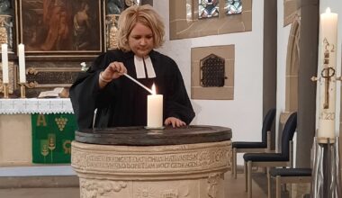 Sandra Sternke-Menne steht in der Ev. Kirche in Dortmund-Brackel und zündet eine Kerze an.