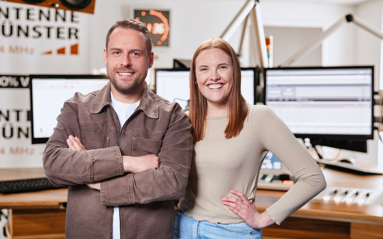Tino Tiede und Malena Stöhler stehen lächelnd im ANTENNE MÜNSTER-Studio.