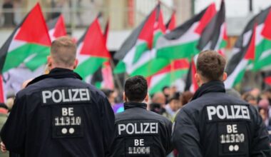 Archivbild: Palästinensische Fahnen werden während einer propalästinensischen Demonstration hinter Polizeibeamten geschwungen. (Quelle: dpa/Gollnow)