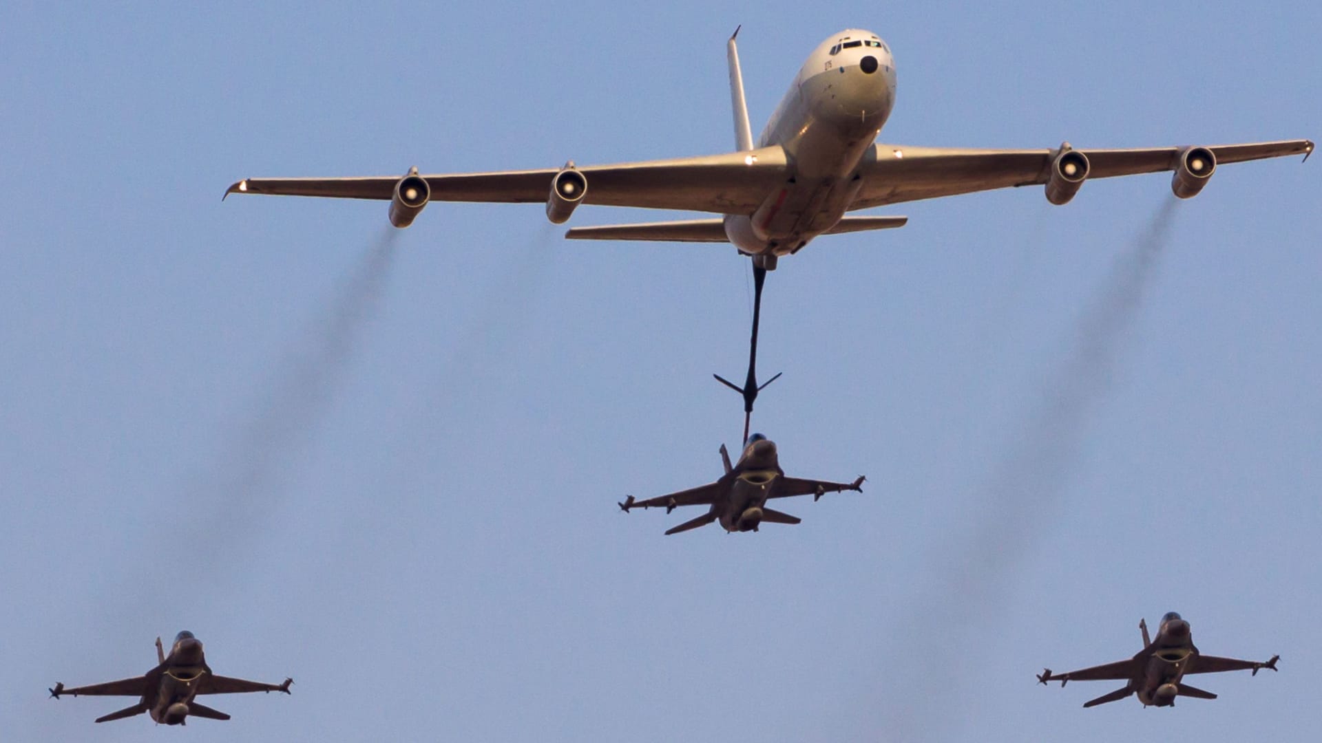Israeli Air Force F-16 jets flying in close formation with a tanker aircraftduring an airshow at Hatzerim, Israel