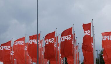 Fahnen mit dem SPD-Logo flattern im Wind.