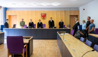 Grit Burzer (M), Vorsitzende Richterin, eröffnet den Prozess nach der Messerattacke von Casekow. Der heute 28-jährige Angeklagte (4.v.r) soll im Januar 2025 eine Frau und ihren Sohn getötet haben. (Quelle: dpa/Stache)