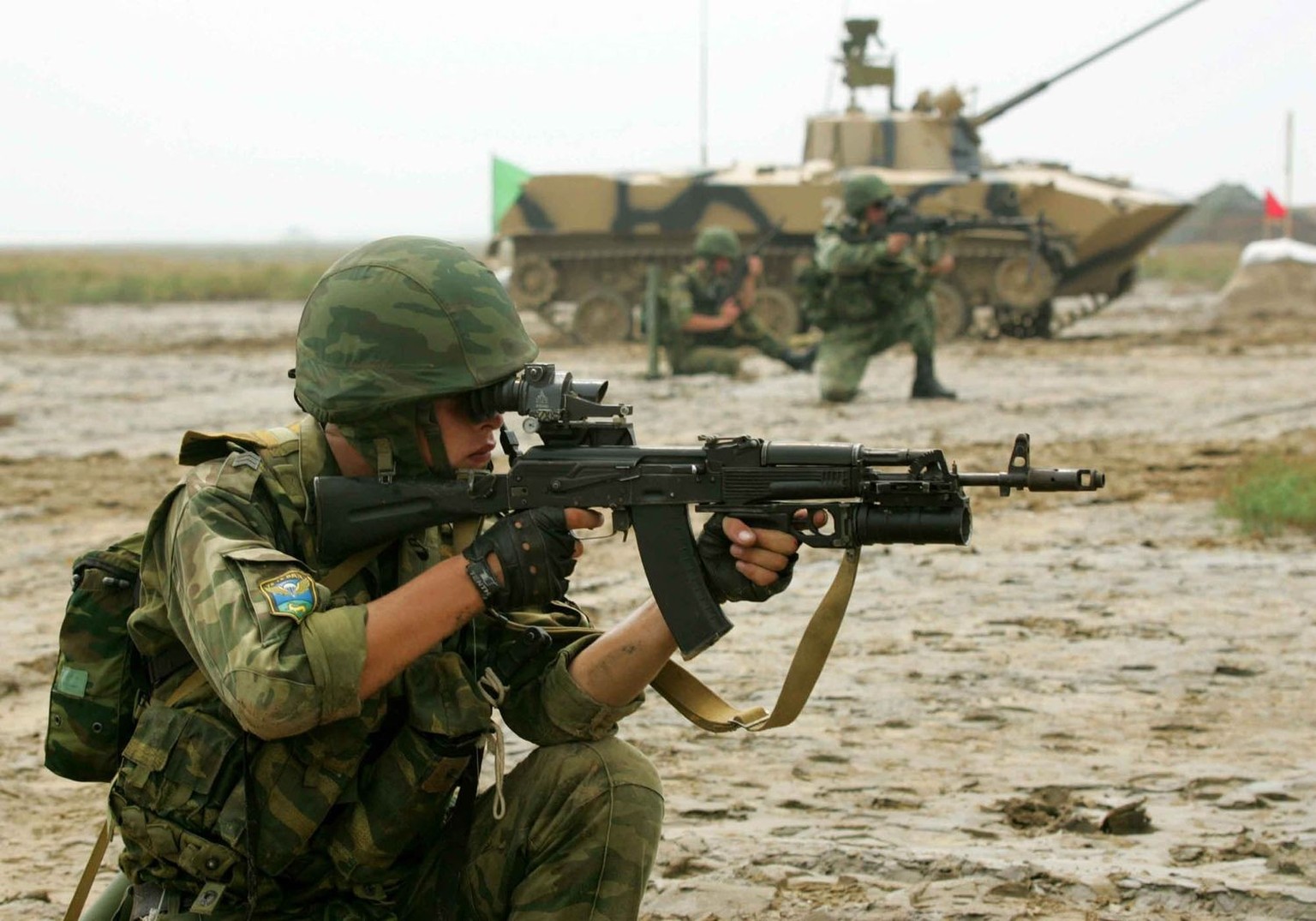 Russian airborne soldiers coordinate with paratroops' combat vehicles to attack targets during a forced isolation drill in east China's Shandong Province, Thursday, Aug 25, 2005. Chinese and ...