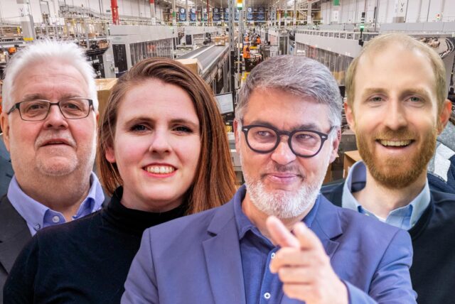 Die Spitzenkandidaten der größten Parteien für die Ratswahl 2025 (v.l.): Michael Kauch (FDP), Heiner Garbe (AfD), Katrin Lögering (Grüne), Thomas Westphal (SPD), Jendrik Suck (CDU), Utz Kowalewski (Linke). Im Hintergrund: Eine Logistikhalle von Amazon auf dem Westfalenhütten-Gelände.
