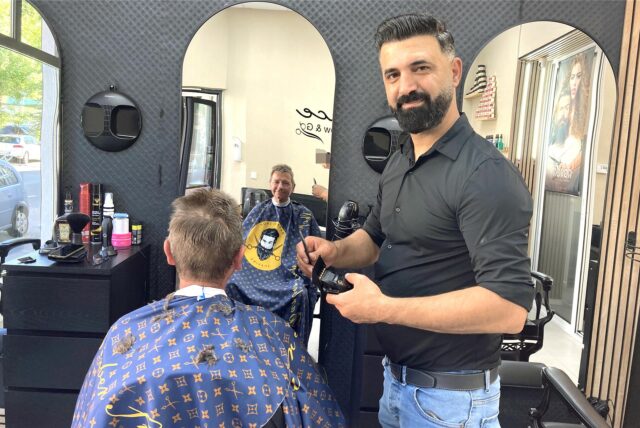 Rezan Younes in seinem Friseurgeschäft an der Gildenstraße 30 in Dortmund-Hörde: Er schneidet einem Herrenkunden die Haare.