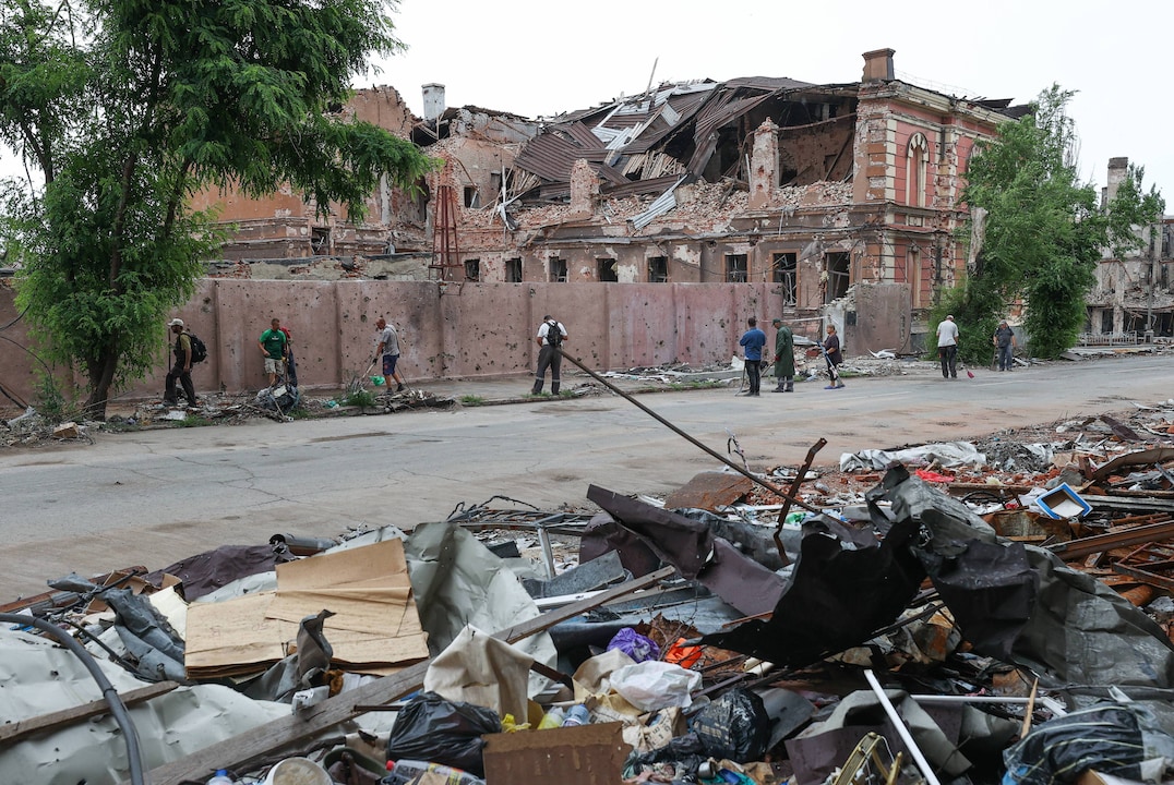 MARIUPOL, UKRAINE - JUNE 27, 2022: Local people clear the rubble in the city of Mariupol, which is controlled by the Don