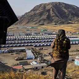 31.05.2025, Afghanistan, Torkham: Ein Taliban-Kämpfer steht auf einem Hügel mit Blick auf ein Lager, in dem afghanische Flüchtlinge untergebracht sind, die aus Pakistan zurückgeführt wurden, nahe der pakistanisch-afghanischen Grenze in Torkham, Afghanistan.(Quelle:dpa/AP/E.Noroozi)