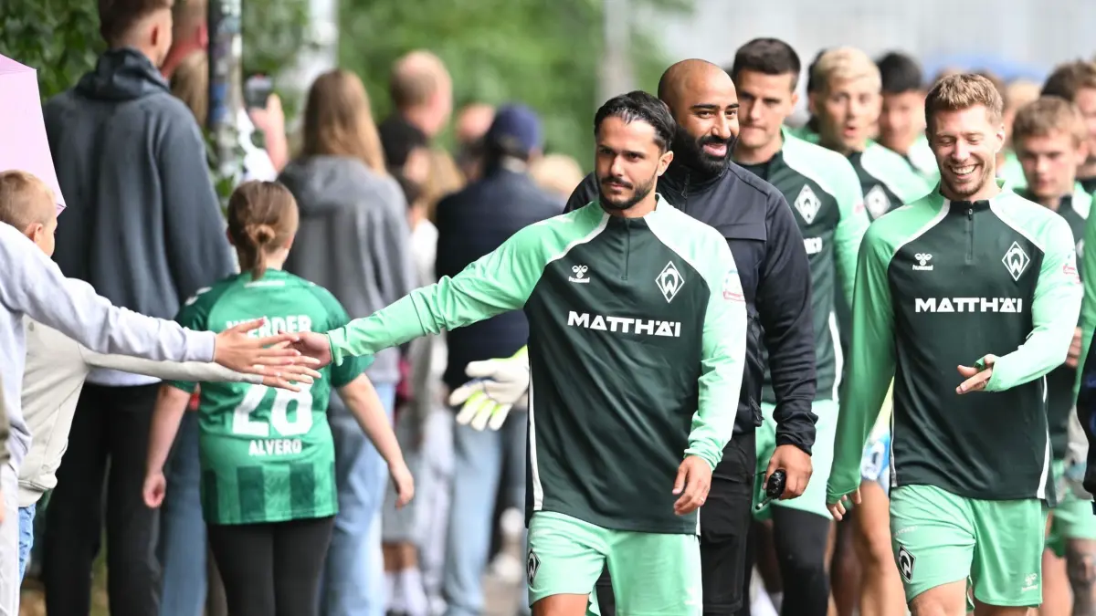 Trainingsauftakt Werder Bremen: 07.07.2025, Bremen: Fußball: Bundesliga, Trainingsauftakt von Werder Bremen, Werders Leonardo Bittencourt begrüßt auf dem Weg zum ersten Training die Fans. Foto: Carmen Jaspersen/dpa - WICHTIGER HINWEIS: Gemäß den Vorgaben der DFL Deutsche Fußball Liga bzw. des DFB Deutscher Fußball-Bund ist es untersagt, in dem Stadion und/oder vom Spiel angefertigte Fotoaufnahmen in Form von Sequenzbildern und/oder videoähnlichen Fotostrecken zu verwerten bzw. verwerten zu lassen. +++ dpa-Bildfunk +++