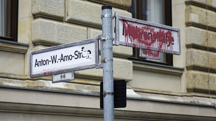 Archivbild: Das Straßenschild in der Mohrenstraße in Berlin Mitte wurde mit roter Farbe beschmiert - der neue Straßenname "Anton-Wilhelm-Amo-Straße" wurde auf das Straßenschild daneben geklebt. (Quelle: dpa/Steinach)