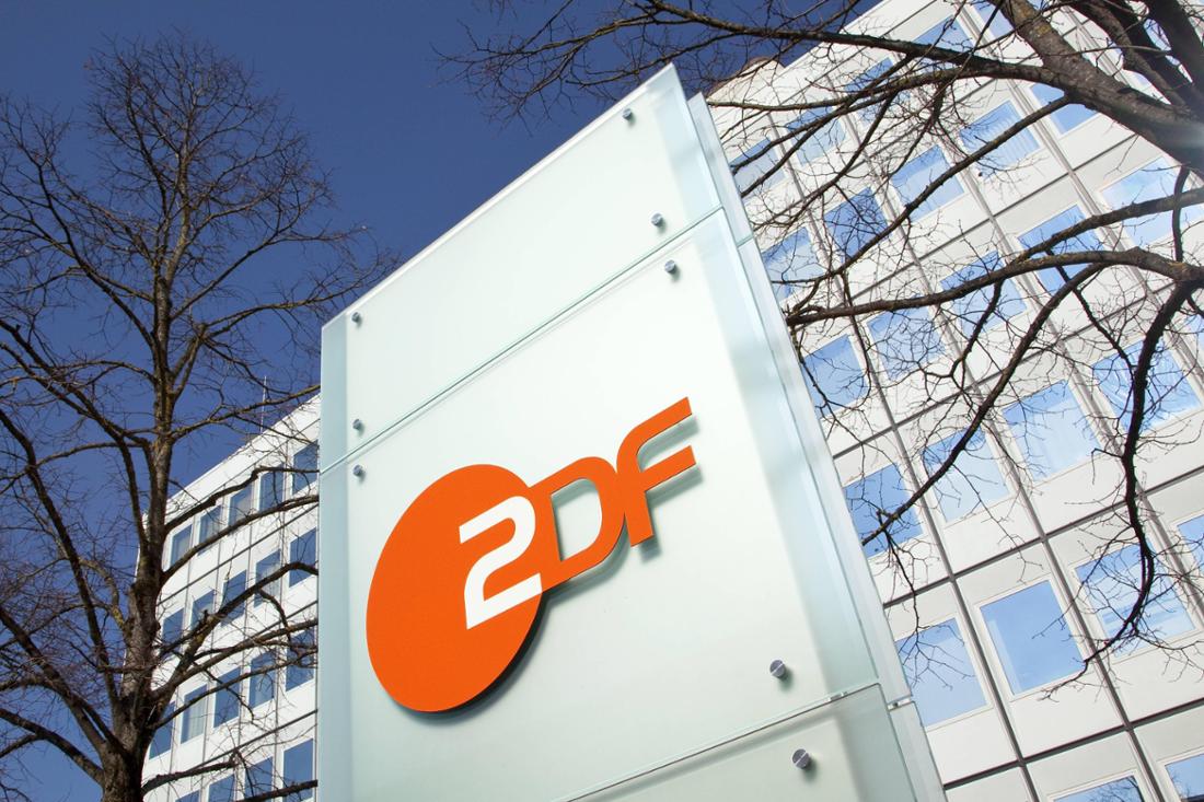 ZDF-Logo vor dem Gebäude des Landesstudio Bayern in Unterföhring bei München.