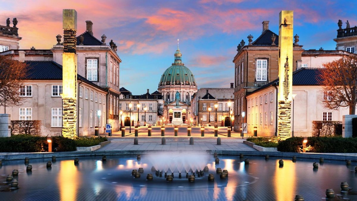 Copenhagen - Beautiful fountain at the Royal Danish Palace Amalienborg at dramatic sunrise. Royal residence, Denmark