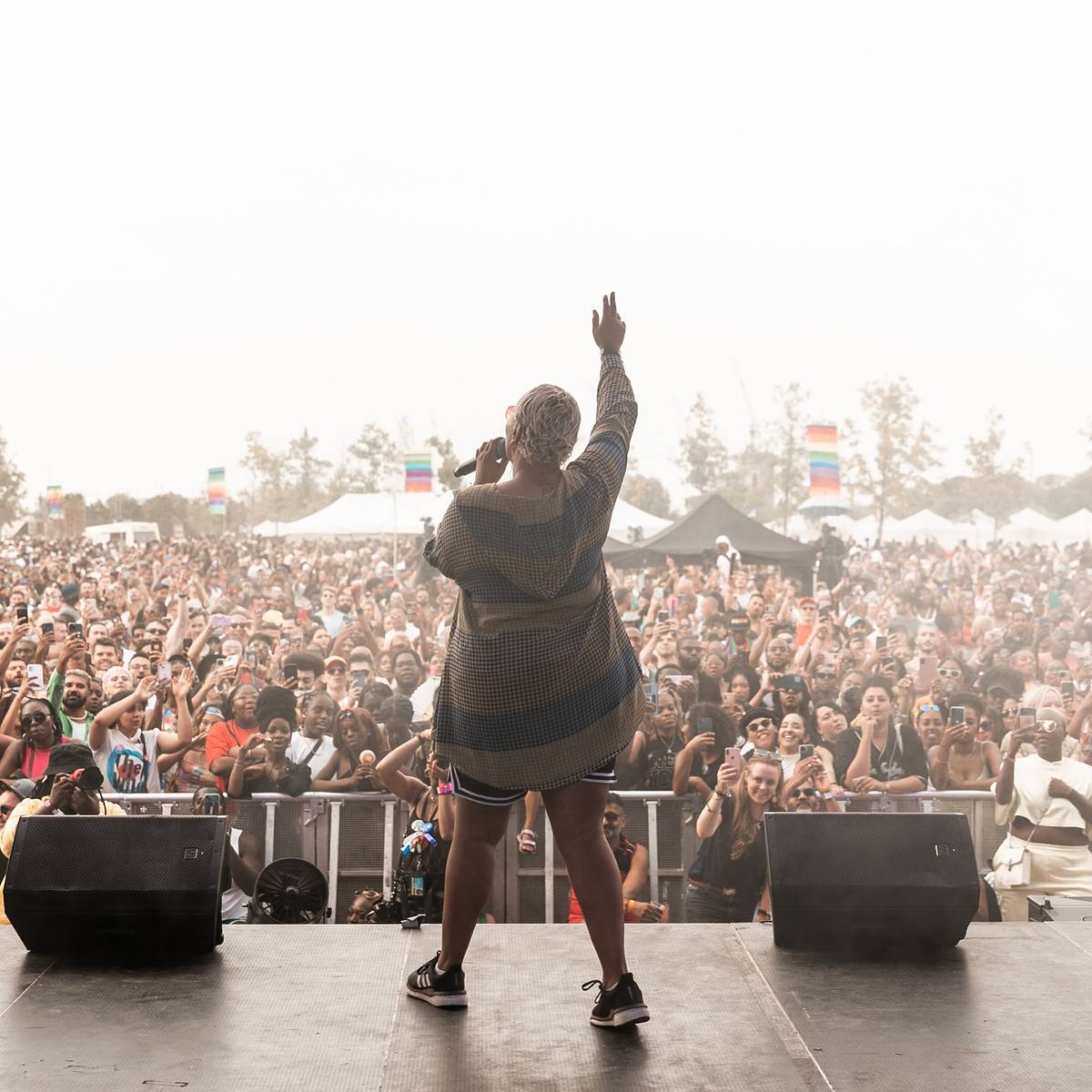 Performer on stage in front of packed-out crowd.