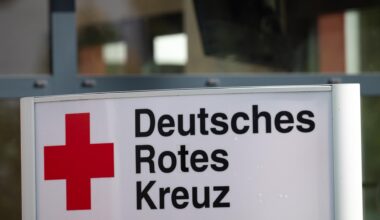Ein Schild mit der Aufschrift "Deutsches Rotes Kreuz" (DRK) steht vor dem Eingang eines Hauses.