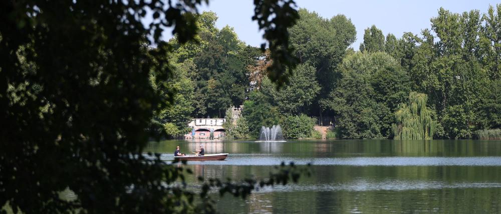 Menschen sitzen in einem Ruderboot auf dem Weißen See in Berlin-Weißensee. 