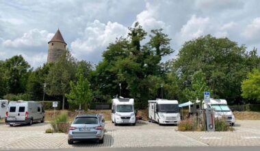 Ein Bild von einem Wohnmobil, das auf einer offenen Straße fährt und Reisen symbolisiert.