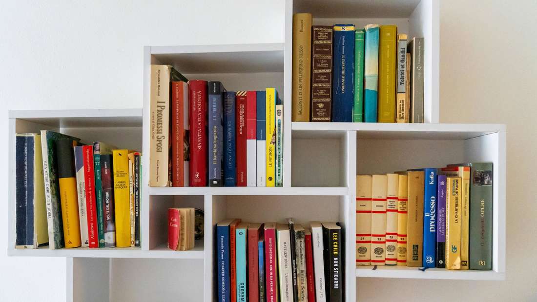 Nago-Torbole, Lake Garda, Italy: July 13, 2025: A modern shelf full of books in various languages - from novels to class