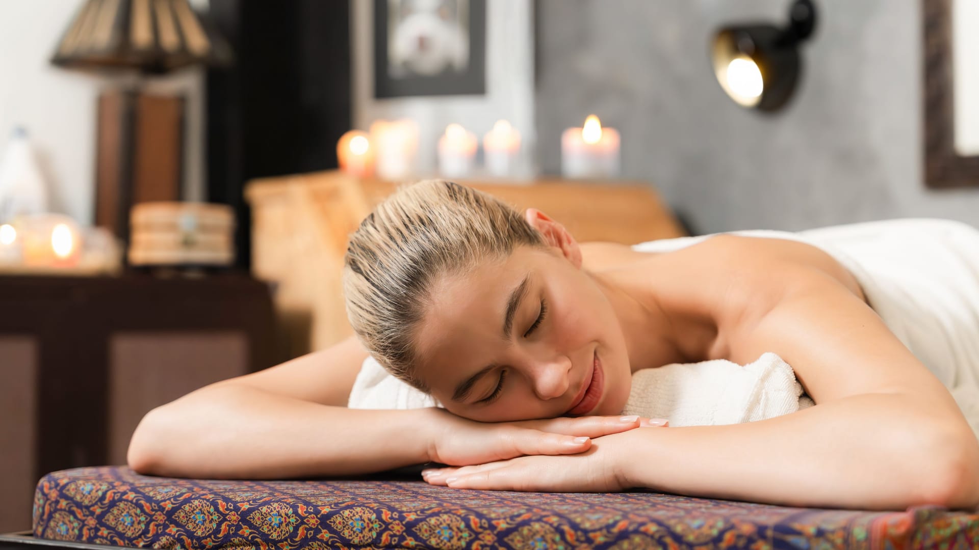 Beautiful caucasian woman lie on spa bed in front of sauna cabinet. Tranquility.