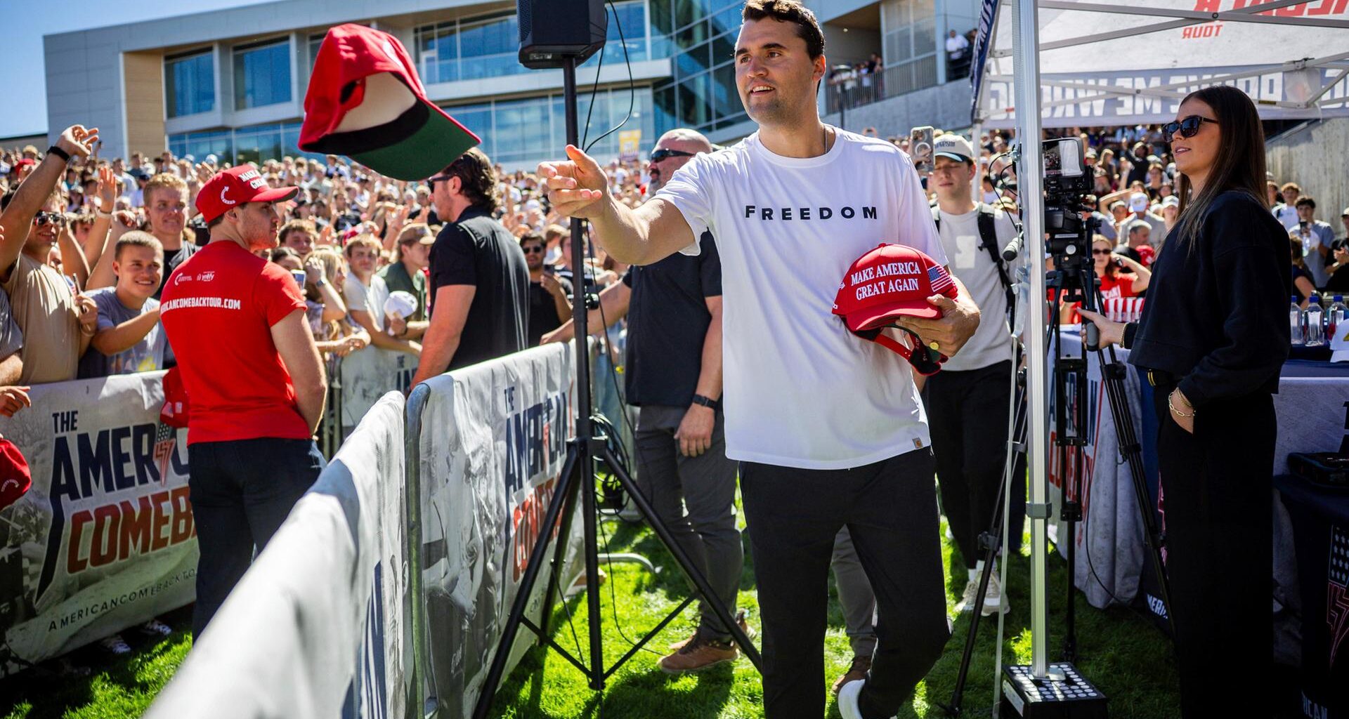 Charlie Kirk verteilt vor seiner Rede an der Utah Valley University Mützen.