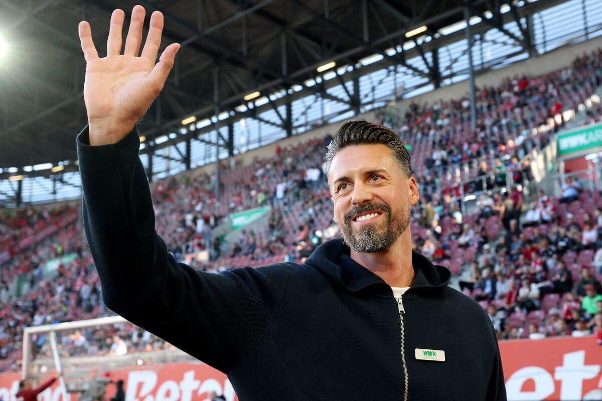 AUGSBURG, GERMANY - AUGUST 30: Sandro Wagner, head coach of FC Augsburg smiles prior to the Bundesliga match between FC Augsburg and FC Bayern München at WWK-Arena on August 30, 2025 in Augsburg, Germany. (Photo by Alexander Hassenstein/Getty Images)