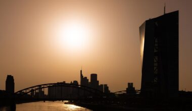 Die Sonne steht hoch über der Europäischen Zentralbank (EZB) und der Frankfurter Bankenskyline.
