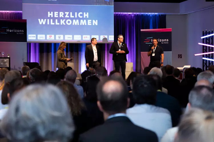 Sprecher auf der horizons by heise Konferenz – Veranstaltung mit Publikum Bühne mit mehreren Sprechern auf der horizons by heise Konferenz vor Publikum