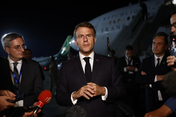 epa12451656 French President Emmanuel Macron answers to journalists as he leaves the Gaza Peace Summitin Sharm El-Sheikh, Egypt, 13 October 2025. US President Donald Trump alongside Egypt's Presi ...