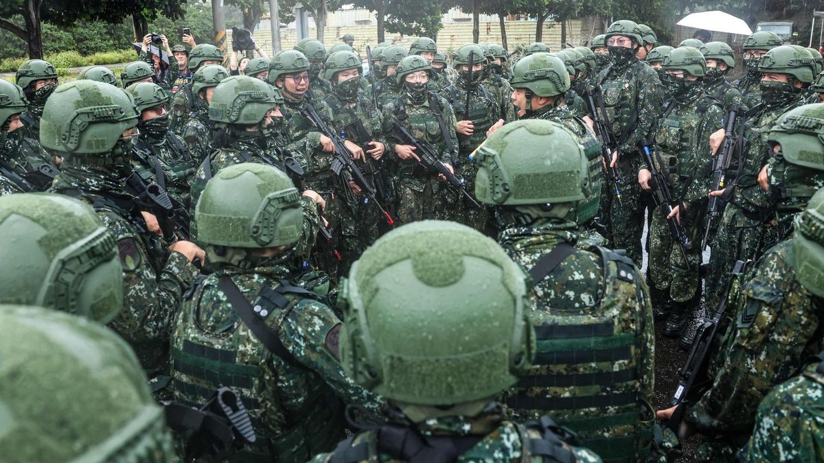 Taiwanese reservists gather to shout slogans after a pre-combat training during Taiwan's annual Han Kuang military exercise in Taoyuan on July 11, 2025. (Photo by I-Hwa Cheng / AFP)