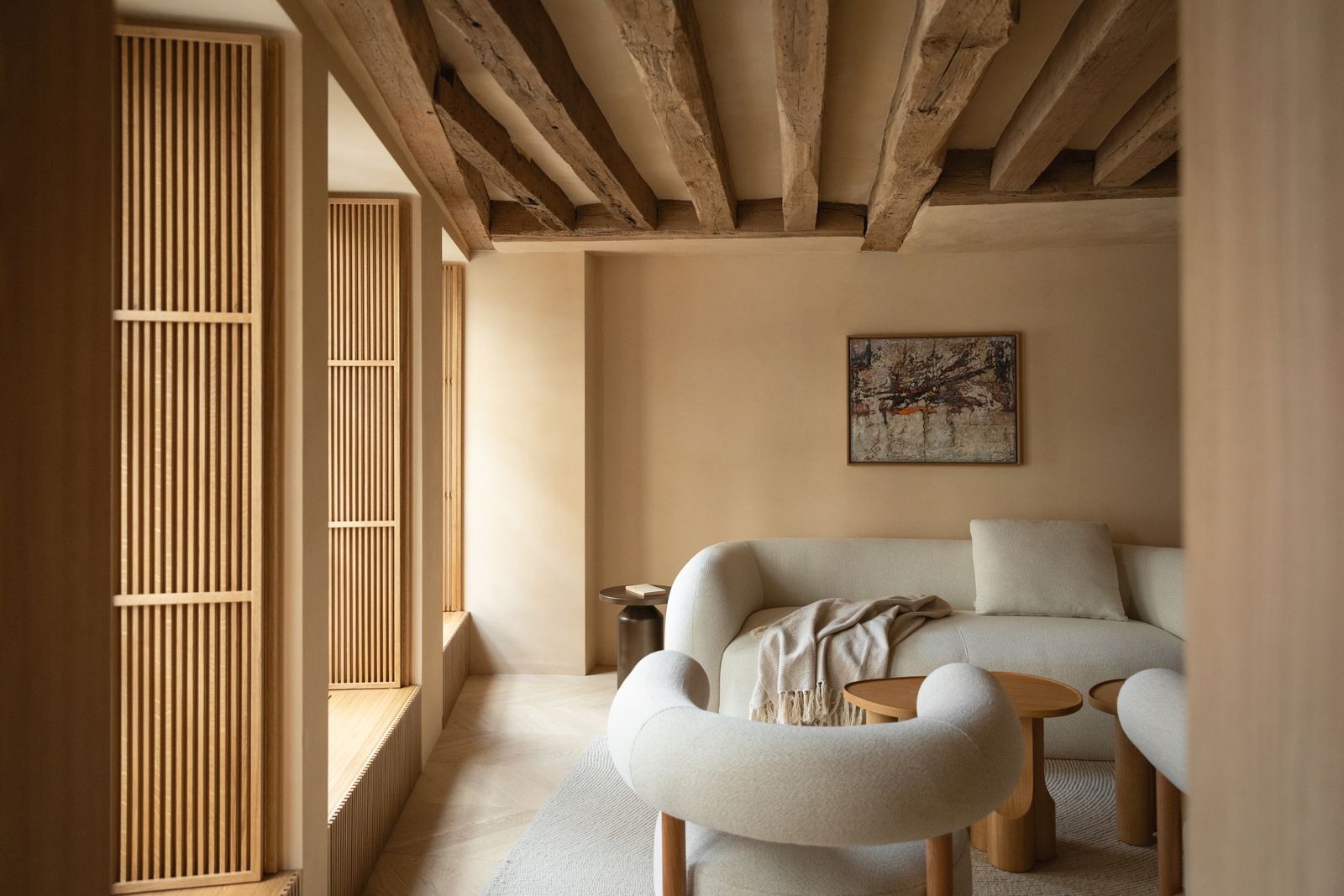 Wohnzimmer in Cremetönen niedrige Decke mit Holzbalken