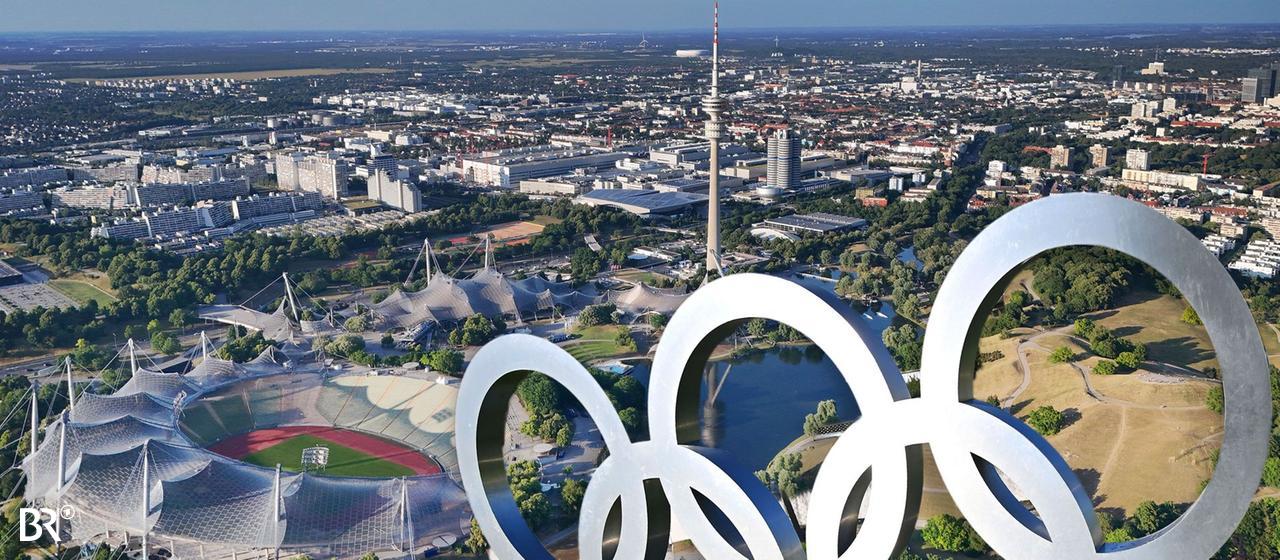 Olympische Ringe vor der Kulisse des Münchner Olympiaparks | picture-alliance Olympische Ringe vor der Kulisse des Münchner Olympiaparks