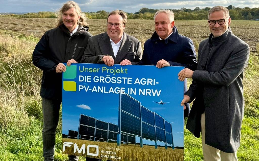 Verantwortliche mit Schild der Agri-PV-Anlage