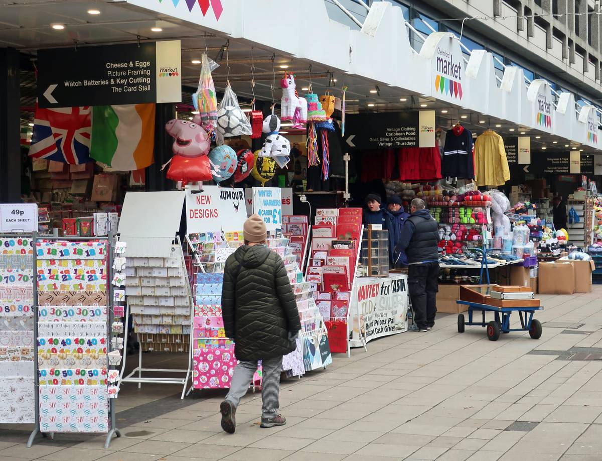 People walking past the market stalls at Chelmsford Market